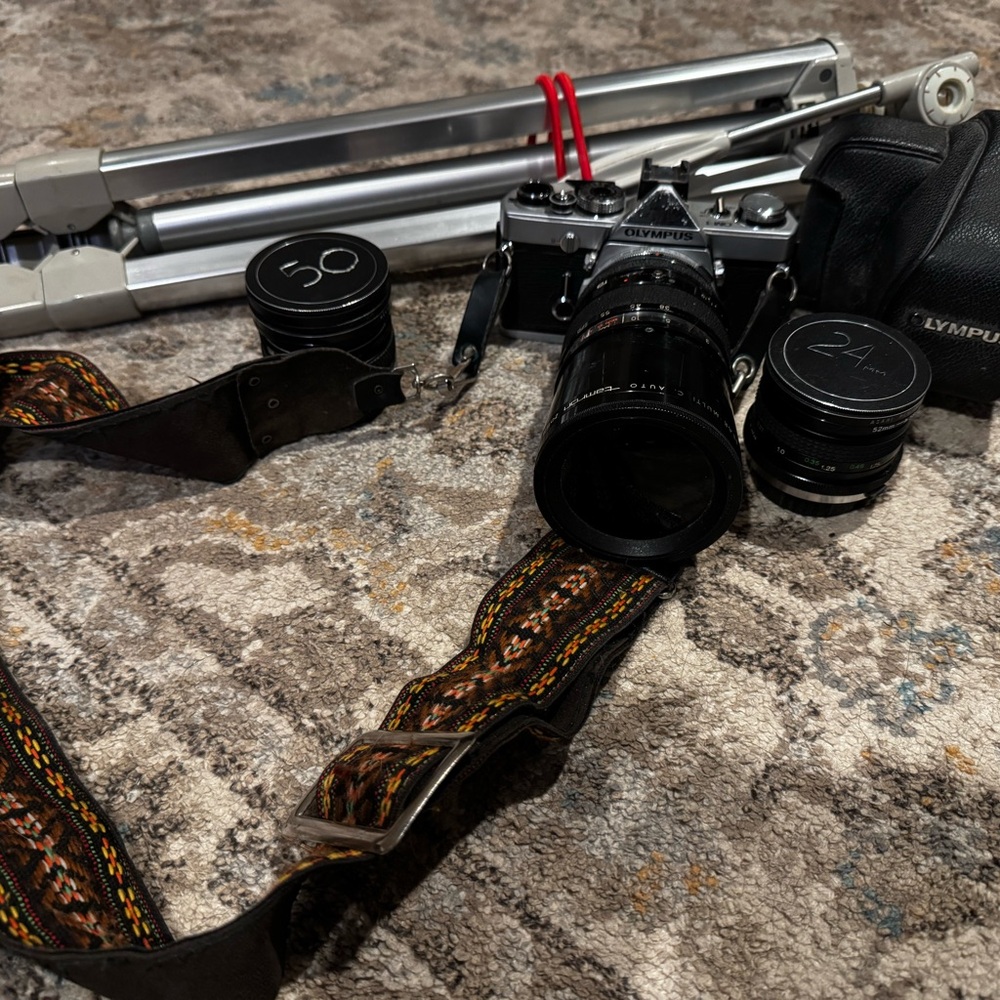 Vintage Olympus Silver and Black Camera with Lenses and Tripod